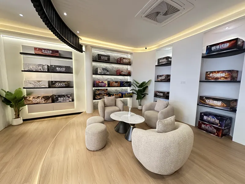 The seating area under the curved slat ceiling: two boucle armchairs, two stools and a round marble table on a raised timber platform.